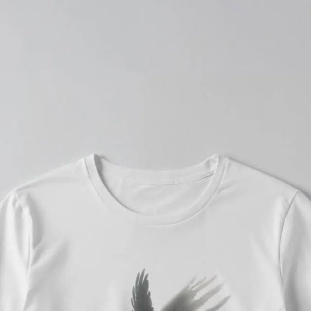 T-shirt with a raven design airbrushed onto the fabric.