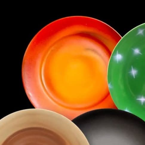 Dining plates decorated with airbrushed colour work.