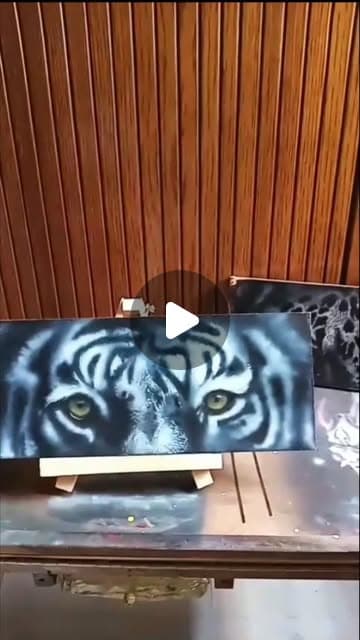 Reel cover of the tiger's eye being airbrushed in close-up.