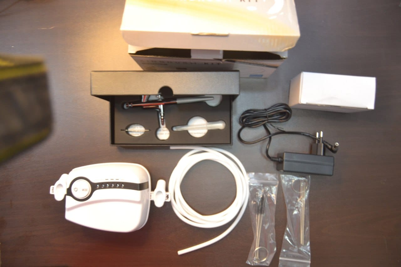 60001 airbrush set with airbrush, compressor, adapter and hose arranged together